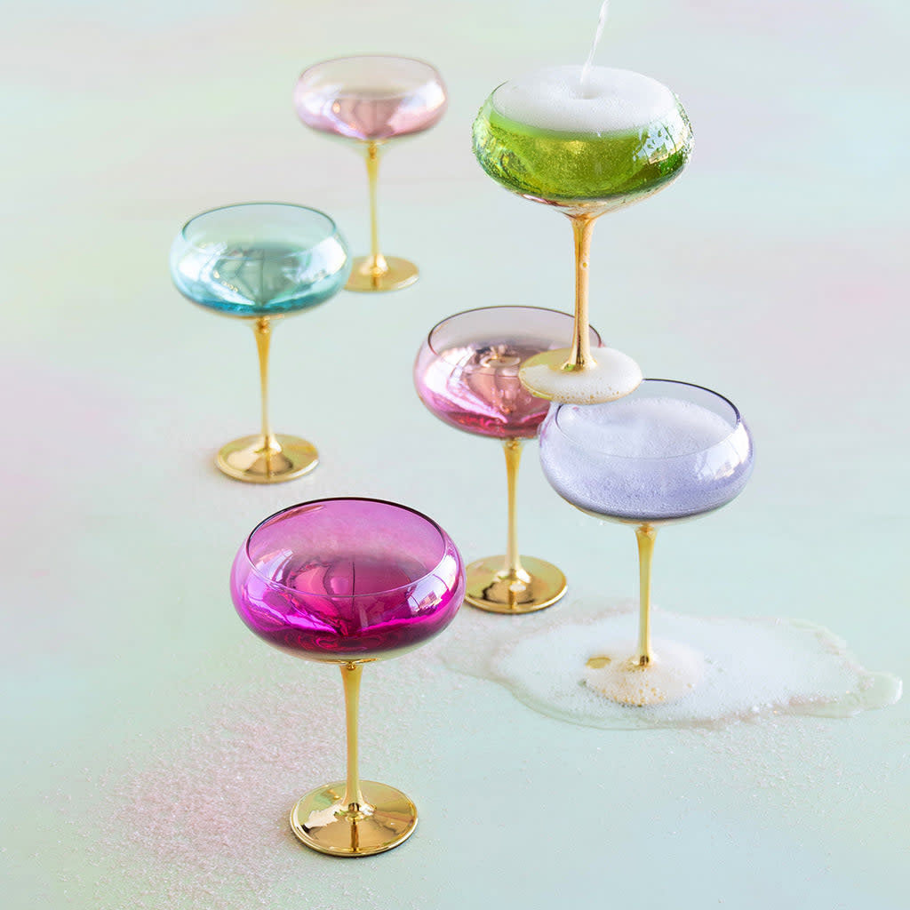 Gilded Coupe glass with real gold accents on a shimmering background