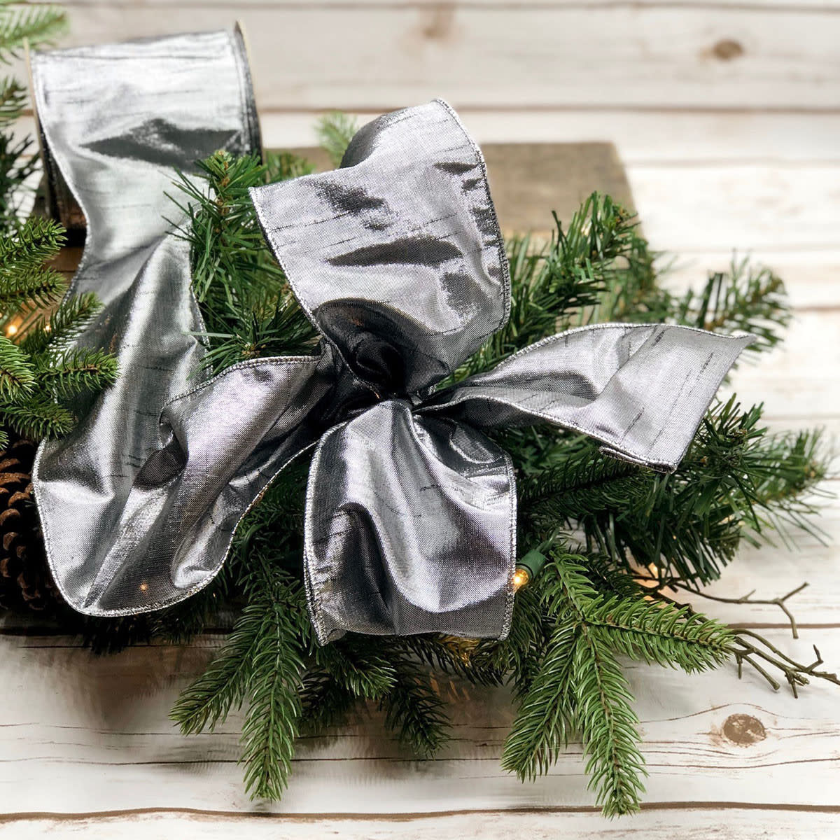Pewter gilded Dupion ribbon with a metallic sheen on a white background.