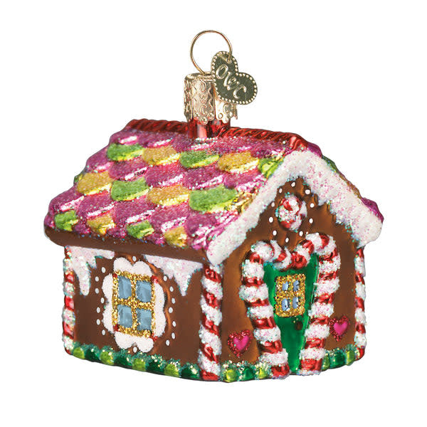 Gingerbread house ornament with candy decorations on a white background.