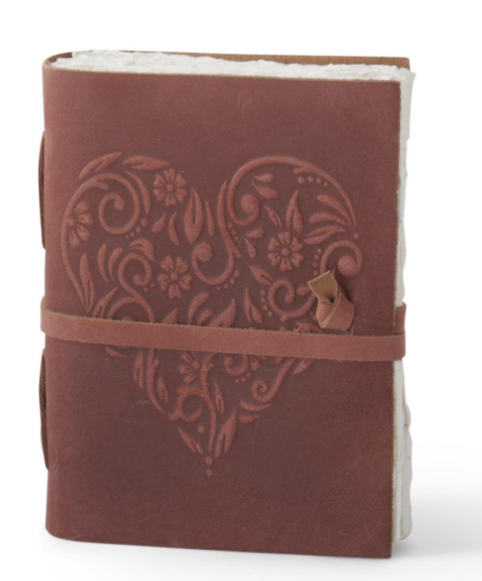 8 inch brown leather journal with an embossed floral heart design and leather strap closure.