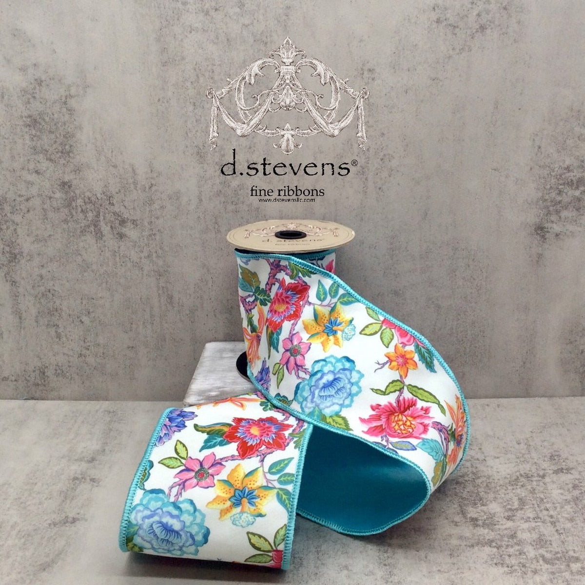 Five yards of pink poplin ribbon with a colorful floral print in blue, yellow, and white.