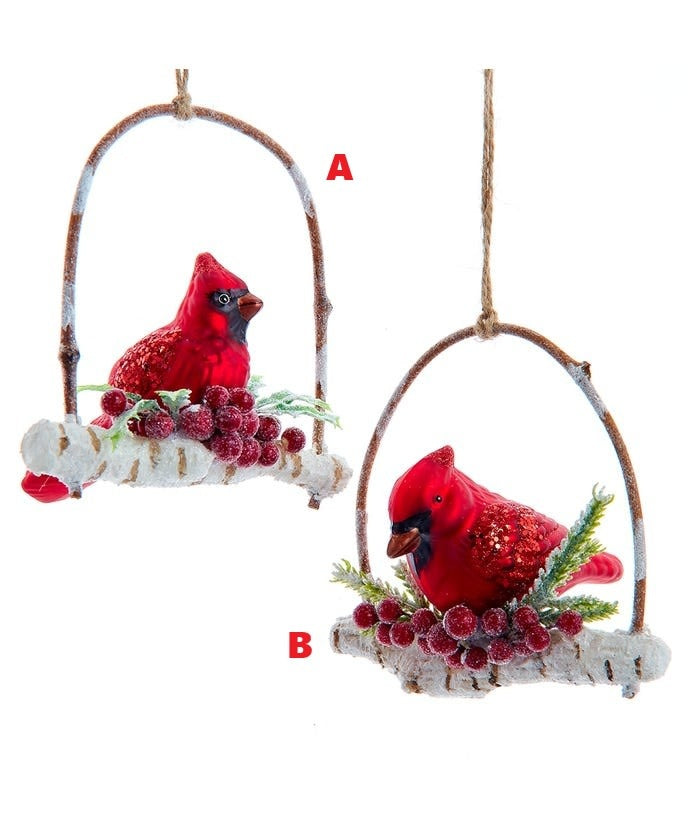 Glass ornament featuring a red cardinal perched on a branch with glittered berries.