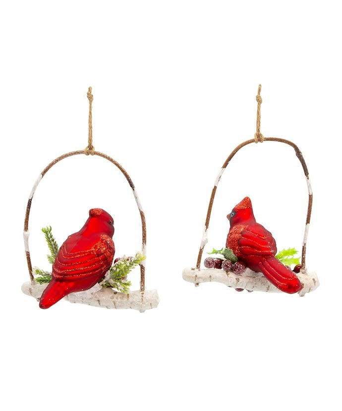 Glass ornament featuring a red cardinal perched on a branch with glittered berries.