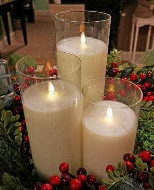 Unscented glass candle with realistic moving flame technology on a white background.