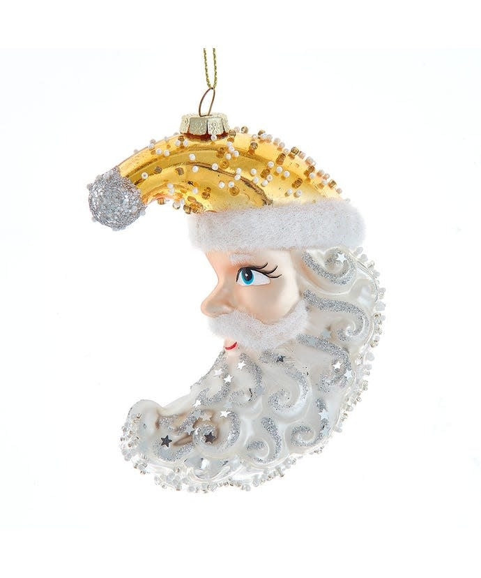 Glass ornament featuring Santa Claus resting on a crescent moon with celestial star patterns.