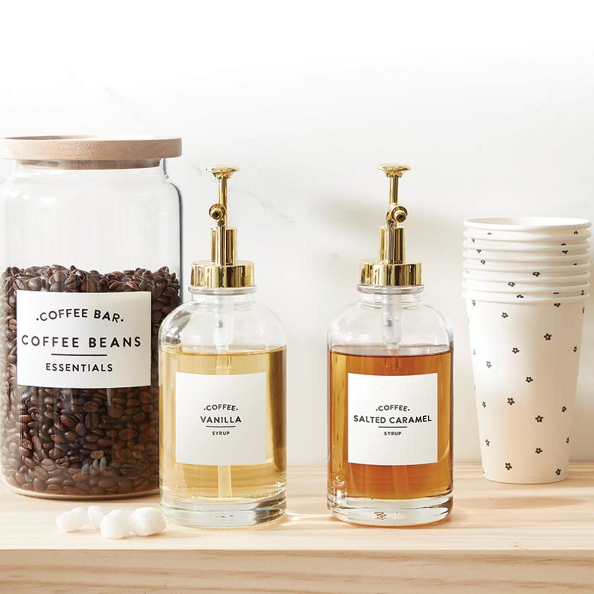Glass coffee syrup dispenser with gold pump lid