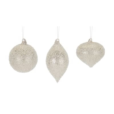 Clear glass Christmas ornament with intricate cut detailing and a shimmering reflective finish.