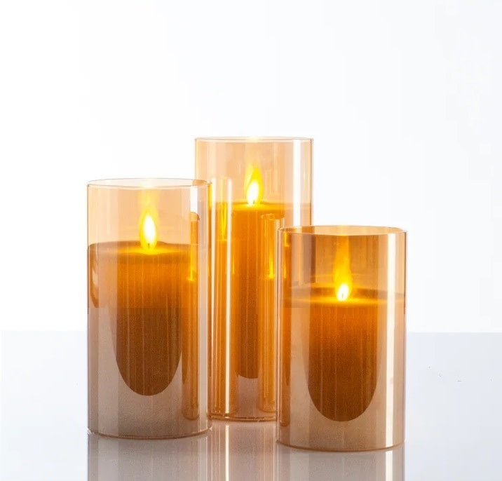 Amber glass pillar candle with a sleek cylindrical shape.
