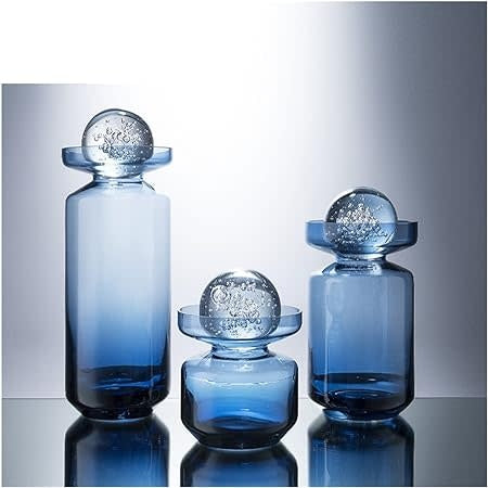 Clear glass vase with a sleek cylindrical shape and smooth finish.