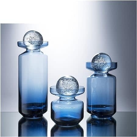 Clear glass vase with a sleek cylindrical shape designed to hold floral arrangements.