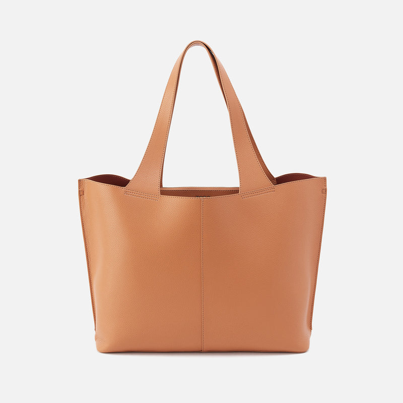 Vida Large Tote in brushed antique brass hardware with coconut shell interior lining.