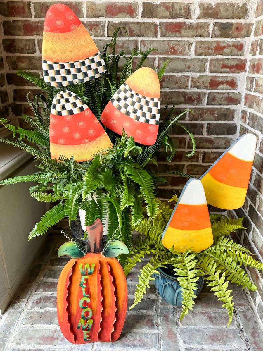 Stakeable glittered candy corn decoration in orange, yellow, and white with a festive Halloween silhouette.