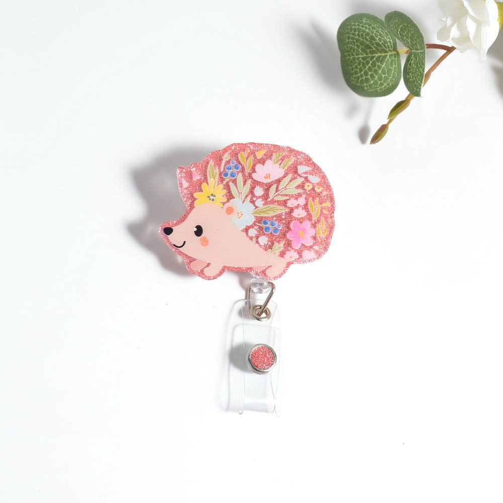 Floral hedgehog badge reel with glitter resin on a spinning alligator clip