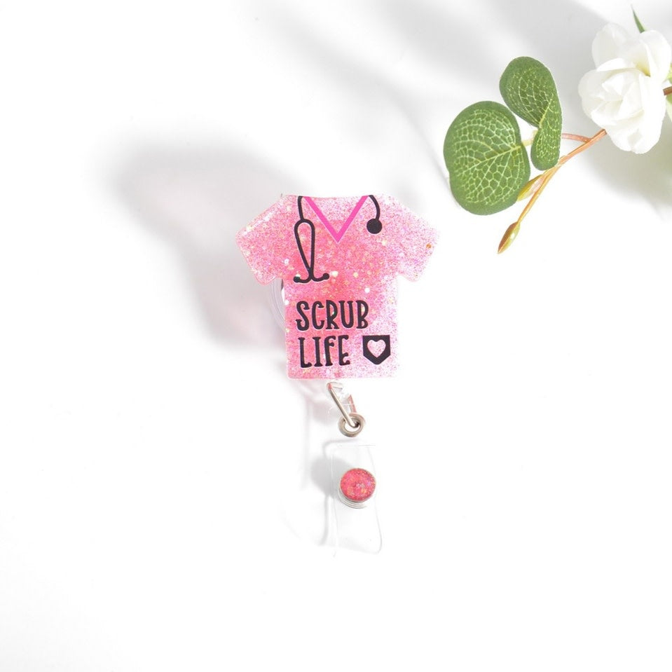 Glitterific badge reel with a clear plastic body, glitter resin heart charm on an alligator clip.