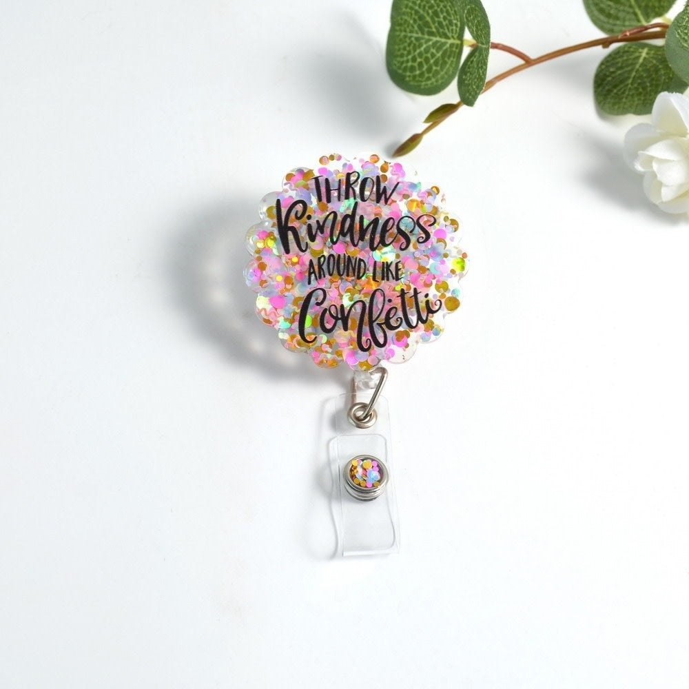 Glitterific badge reel with confetti glitter resin pin featuring a colorful scattered pattern and alligator clip.