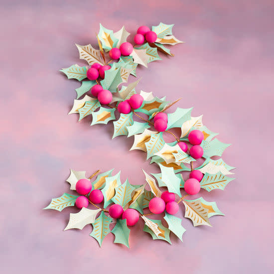 Hand-painted papermache holly garland in green with red berries.
