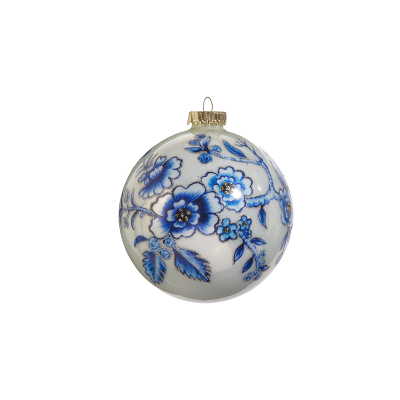 5-inch white glass ball ornament with hand-painted blue floral designs and silver glitter accents.