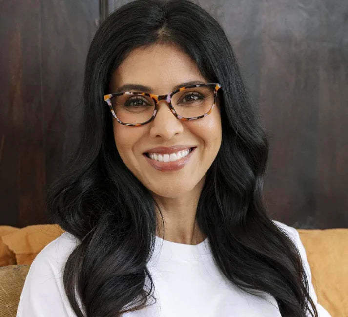 Pink rectangular eyeglasses with shiny botanical leaf patterns on the frame.