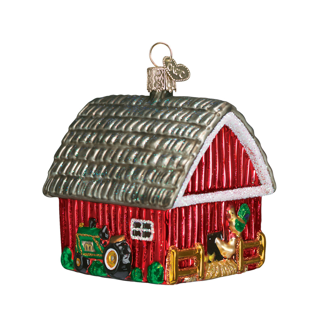 Glass barn ornament with a red body, silver roof, green tractor, and a rooster by a gold fence.