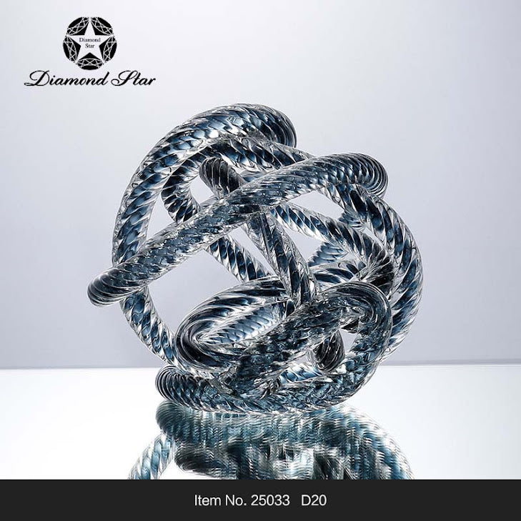 7.9-inch blue and clear glass knot sculpture with a twisted rope texture on a reflective surface.