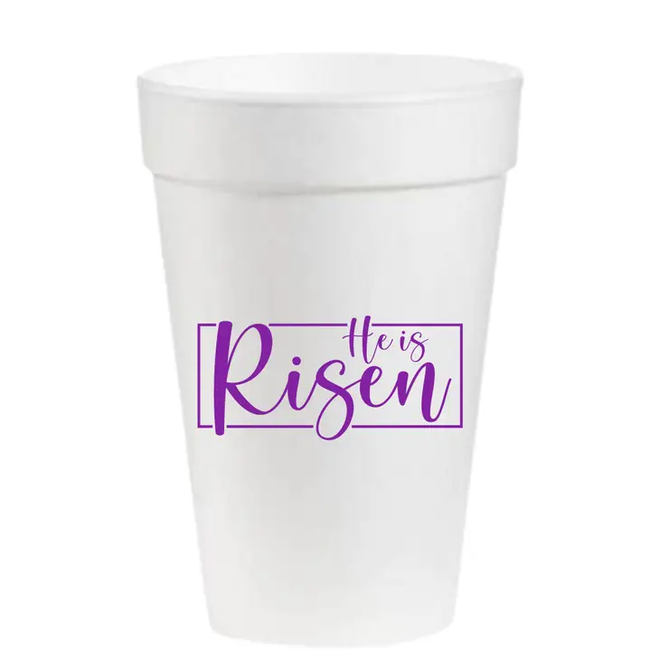 White styrofoam cup with 'He is Risen' Easter text printed in gold.