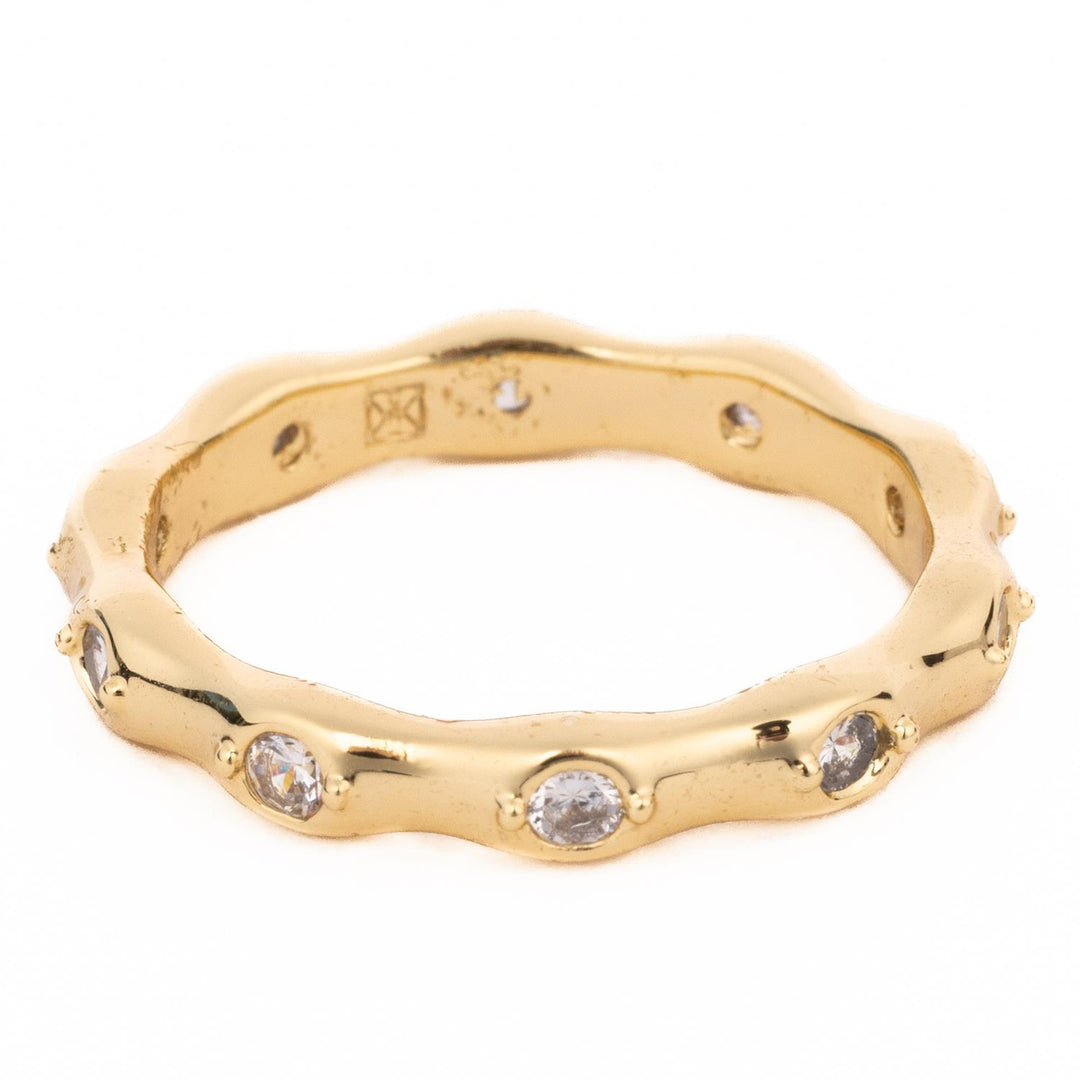 Gold Luxe wavy eternity ring with 18K gold plating and inset clear crystals.