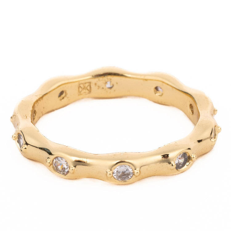 Gold Luxe wavy eternity ring with 18K gold plating and inset clear crystals.
