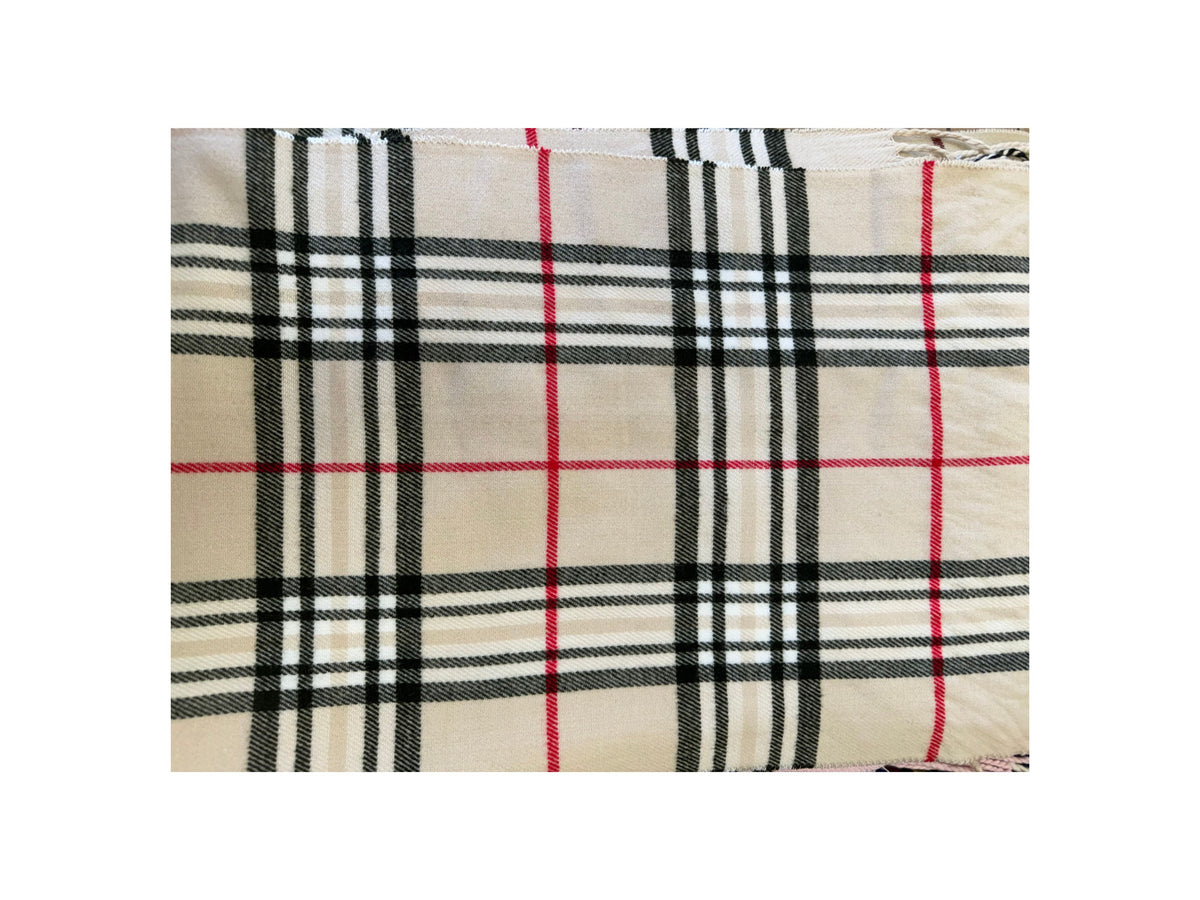 Scottish plaid cashmere scarf in a beige, black, white, and red check pattern.