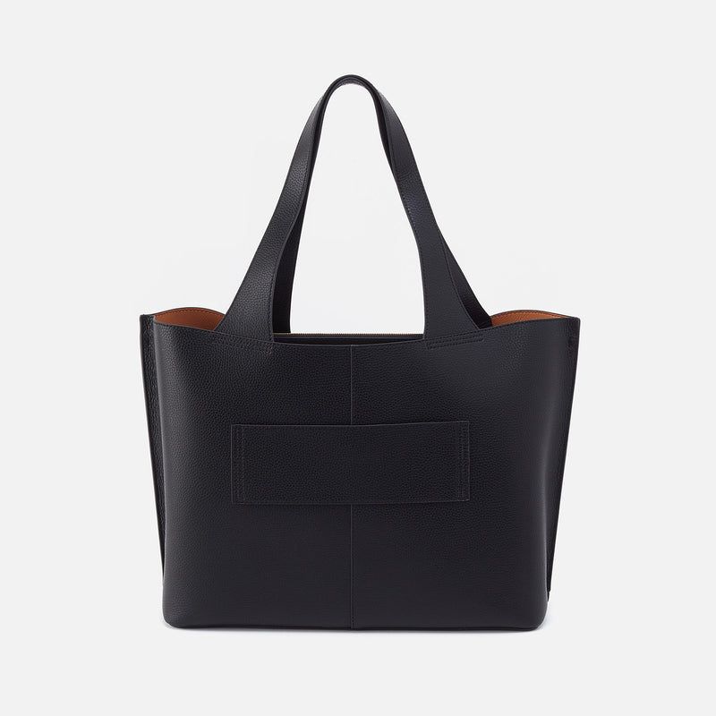 Vida Large tote bag in solid leather with brushed antique brass hardware, coconut shell interior lining, and double straps.