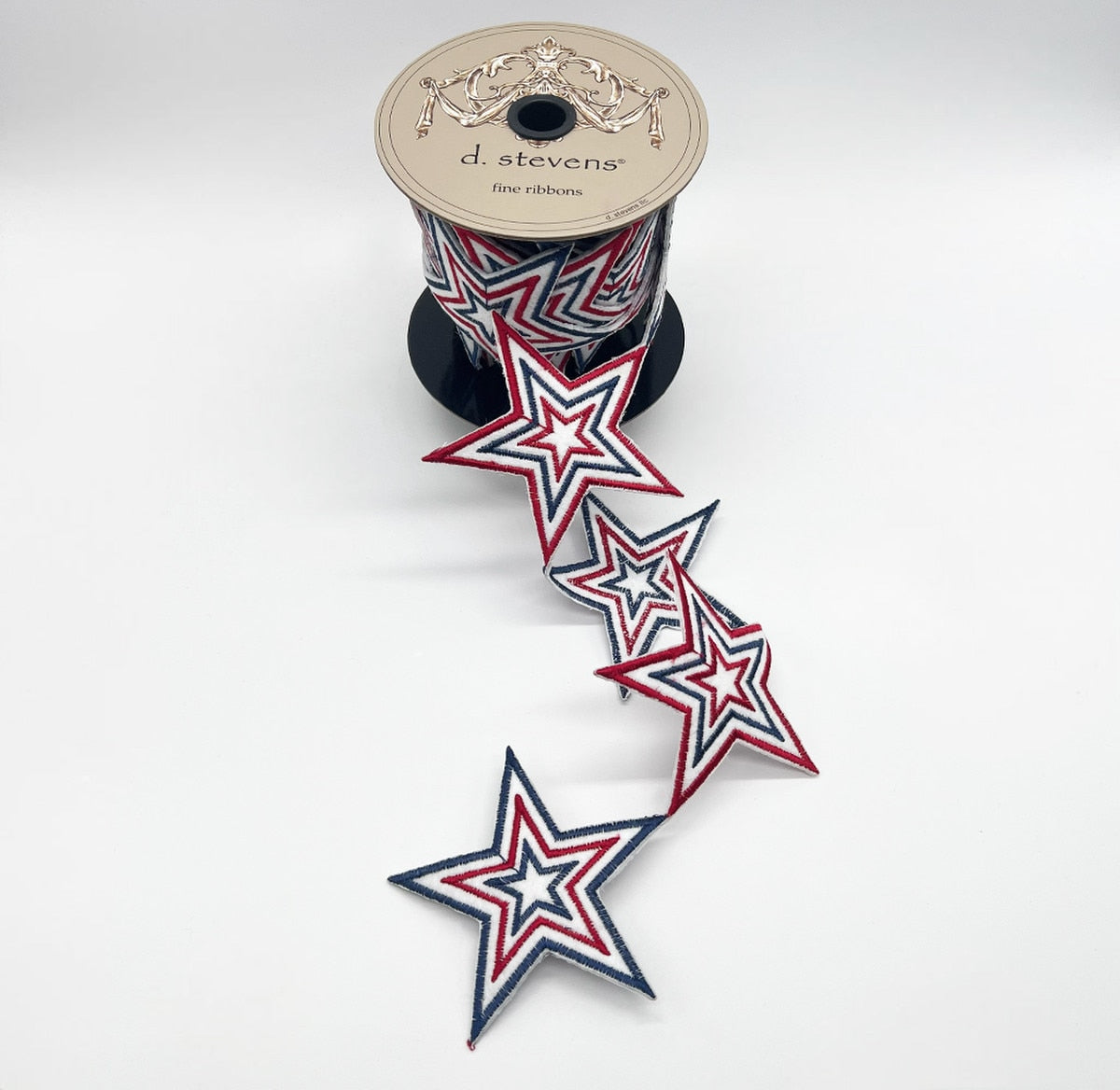 Red felt garland with white stars embroidered on a blue ribbon background