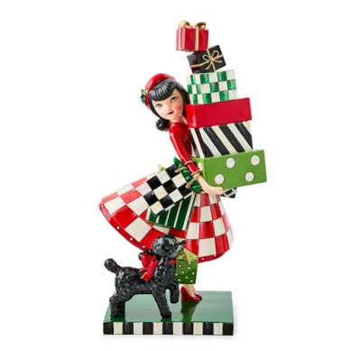 Check It Out Shopper Figurine featuring a woman in a red dress holding a stack of patterned gifts.
