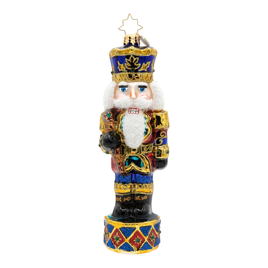 Radiant Jewel Nutcracker glass ornament in ruby, emerald, and sapphire with a golden crown.