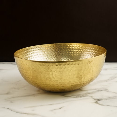 Gold hammered aluminum round bowl with a reflective finish