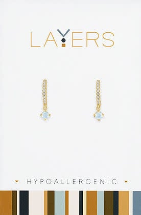 Gold huggie hoop earrings featuring petite opal cubic zirconia stones.