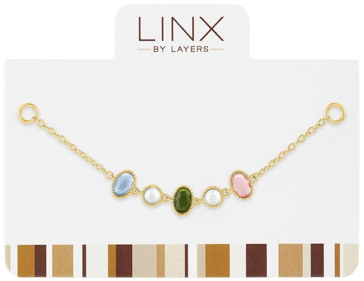 Gold oval LINX add-on with multi-color stones in a sleek metallic finish.