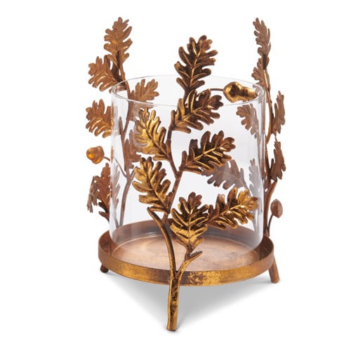 Gold oak leaf iron base with clear glass insert holding a candle