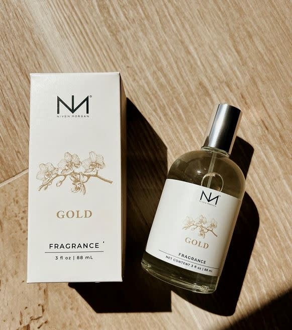 Gold Perfume bottle with a metallic gold finish and clear glass body.