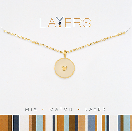 Gold layered necklace featuring round heart-shaped disc pendants on a chain.