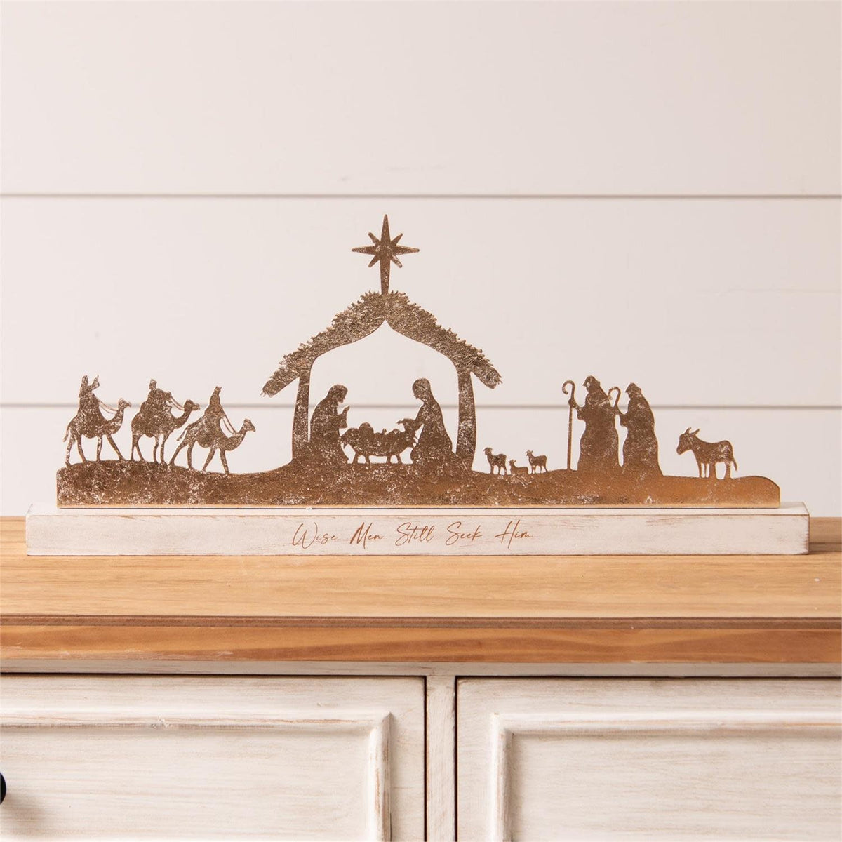 Gold shimmer nativity silhouette wall decor made of iron and MDF with an elegant holiday shape.