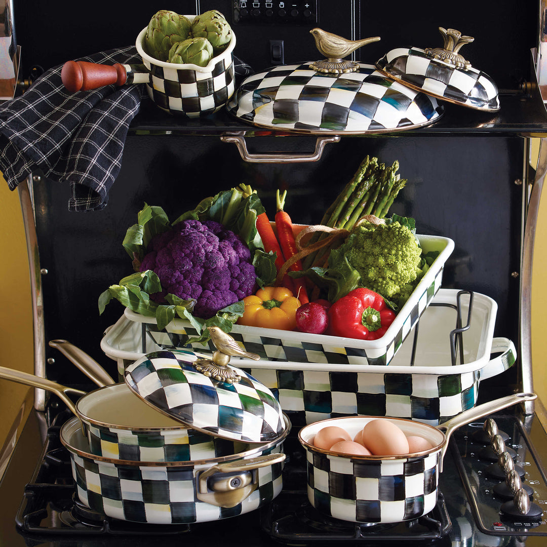 Courtly Check Enamel 3 Quart Saute Pan with lid among other checkered cookware and vegetables.