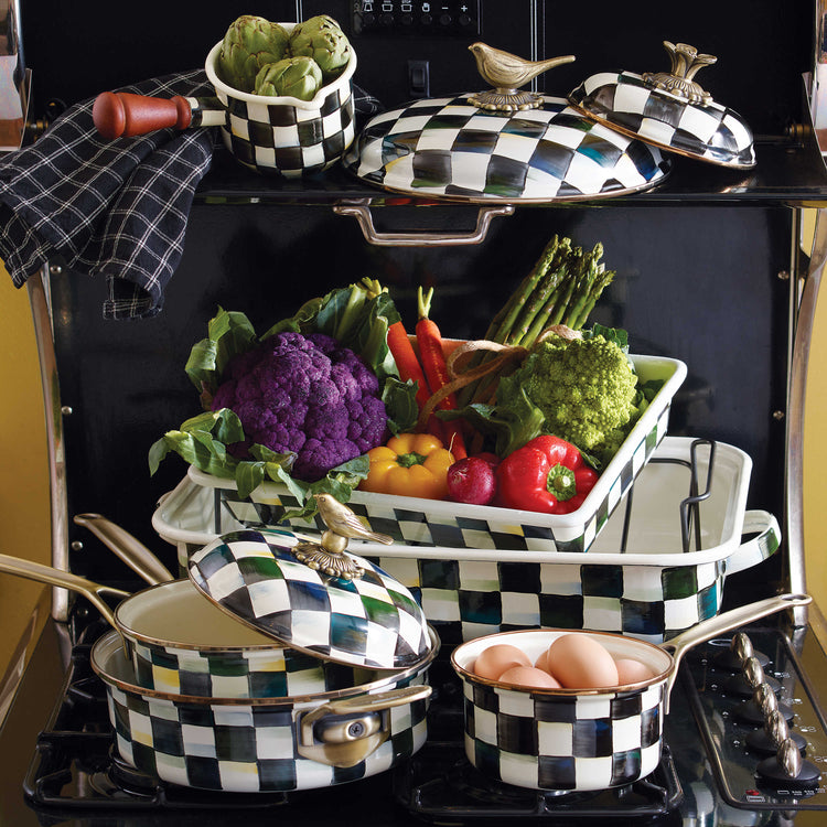 Courtly Check Enamel 3 Quart Saute Pan with lid among other checkered cookware and vegetables.