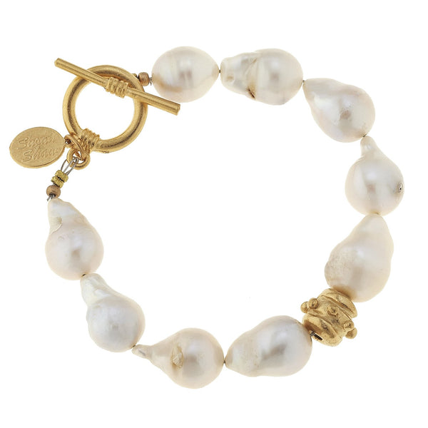 Triple-plated gold toggle clasp bracelet featuring large baroque freshwater pearls.