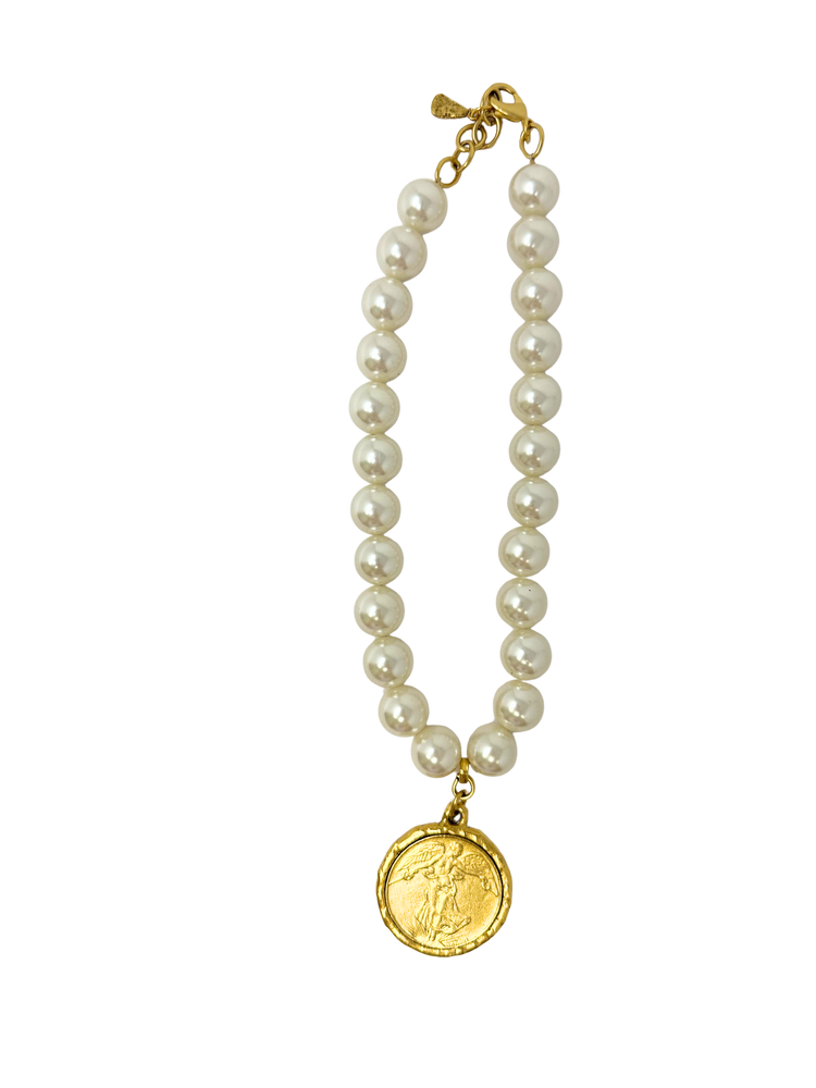 Pearl bead necklace featuring a round gold Liberty coin pendant and a gold-tone lobster clasp.