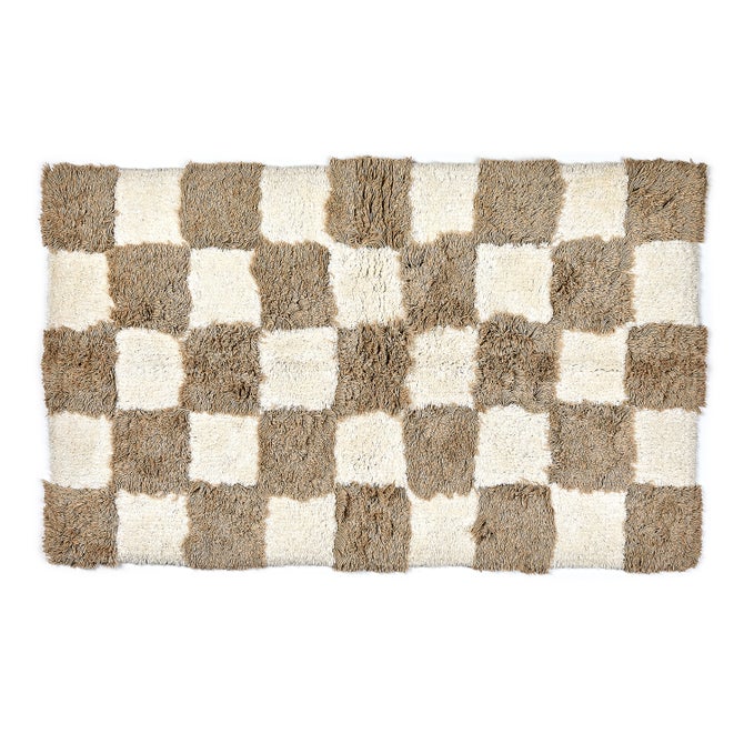 Rectangular taupe and cream checkerboard pattern shag bath rug.