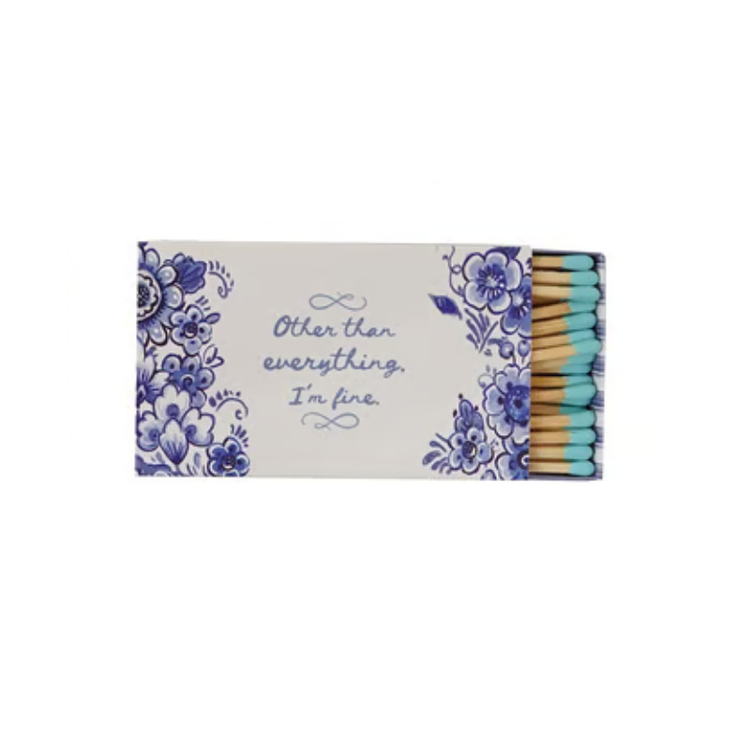Safety matchbox with blue floral design and text reading 'Other than everything, I'm fine.'