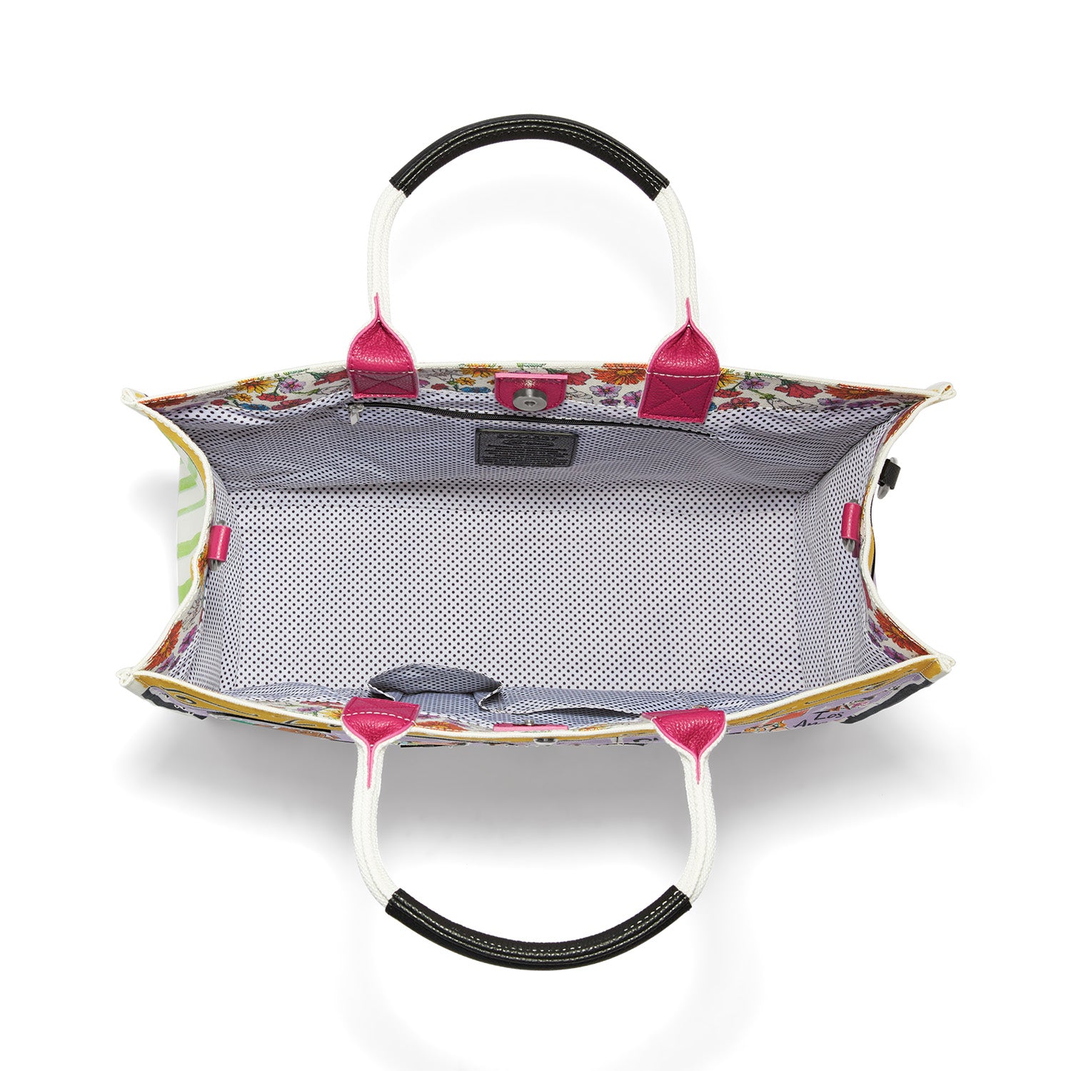 Interior view of a large canvas tote with polka dot lining, magnetic snap, and multiple pockets.