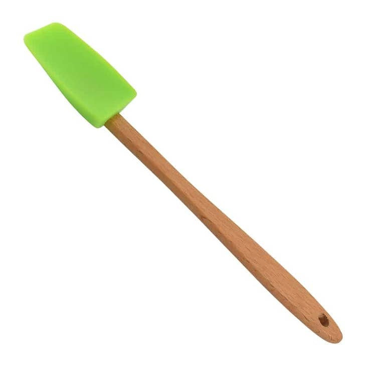 Green silicone mini spatula with a compact handle designed for small spaces.