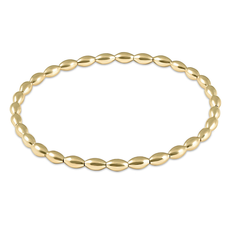 Harmony small gold bead bracelet on high-performance elastic with a slight stretch.