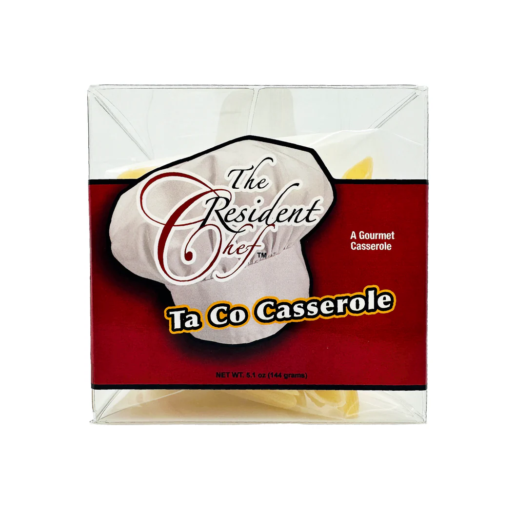 The Resident Chef Ta Co Casserole mix in a clear box with a red label and chef hat logo.