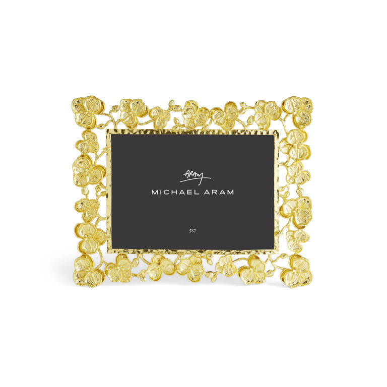 Goldtone metal frame holding a 5x7 photo with an orchid silhouette.